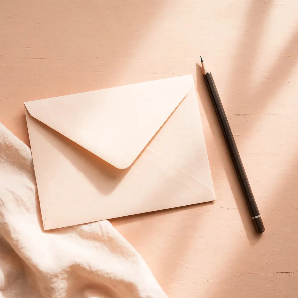 An envelope and a pencil on a desk